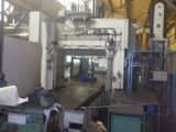 a picture of a factory with a machine and a roll of paper