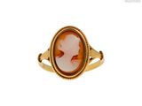 a close up of a gold ring with an oval stone in the center