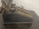 an old typewriter sitting on a table in a room