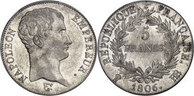 a silver coin with the head of a woman in profile