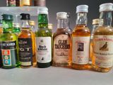 many different types of alcohol bottles lined up on the counter