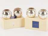 two silver vases sitting on top of a wooden stand