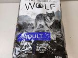 a bag of the hunger wolf adult dry dog food sitting on a counter
