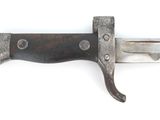 a close up of a knife on a white surface