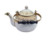 a close up of a tea pot with a bow tie on it