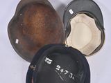 several hats that are sitting on a white surface