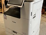 a printer sitting on top of a cart in a warehouse
