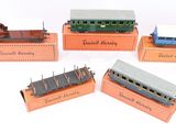 several toy trains are sitting on display on a white surface
