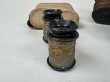 three jars sitting on a table next to a pair of shoes