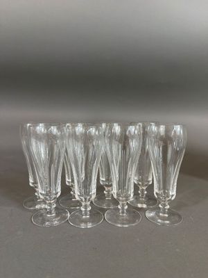 six clear wine glasses are lined up on a table
