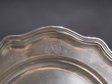 a silver plate with a design on it on a table