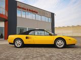 yellow sports car parked in front of a building in front of a building