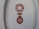 a white plate with a red and white design on it