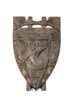 an image of a metal shield with a ship on it