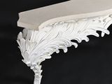 a white shelf with a decorative design on it