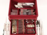a red box with silverware in it on a white surface