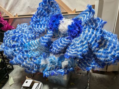 a blue and white dragon made out of yarn on a table