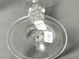 a wine glass with a label on it sitting on a table