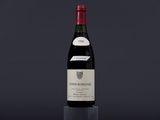 a bottle of red wine sitting on top of a table