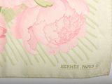 a picture of a pink flower on a green and white towel