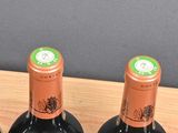 several bottles of wine are lined up in a wooden box