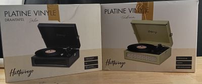 two boxes with a record player sitting on top of a wooden table