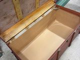 an open trunk sitting on the floor in a room