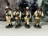 five figurines of soldiers standing next to each other