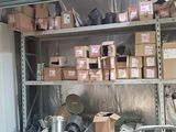 many boxes and cans on the shelves in the garage
