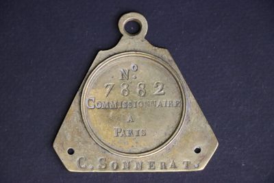 an old brass plate with the name of a town on it