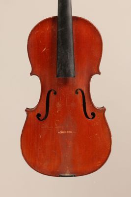 un vieux violon posé sur une surface blanche