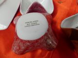 a red and white bowl and a white bowl on a table