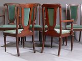 four chairs with green upholstered seats are sitting in a room