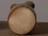 a close up of a vase on a table