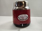 a red blender that is sitting on a table