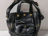 an image of a black handbag with a bow on the front