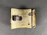 a small metal buckle with a metal latch on it