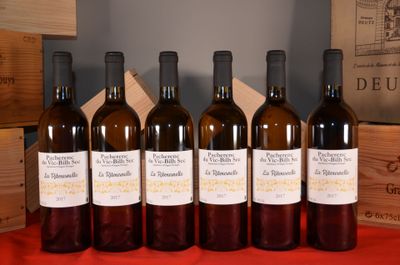 six bottles of wine are lined up on a red table