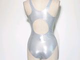 a mannequin on a stand with a white wall in the background