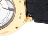 a close up of a watch on a white surface