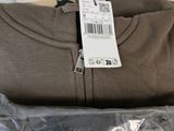a bag of cashmere next to a package of clothing