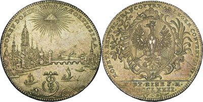 deux vieilles pièces de monnaie sur lesquelles figurent un château et un soleil