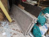 a pile of junk in a garage with a broken window