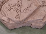 a stone sculpture of a coat of arms and a shield on it