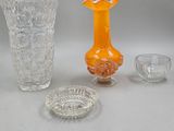 three vases, a bowl, and a bowl on a table