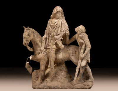 a statue of a man riding a horse with a woman on it