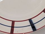 a white plate with red and blue stripes on it