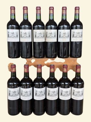 bottles of red wine are lined up on a wooden rack