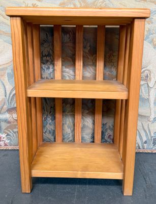 a small wooden shelf with two shelves on it