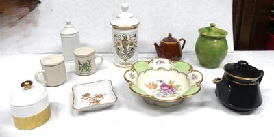 many different types of teapots and cups on the table